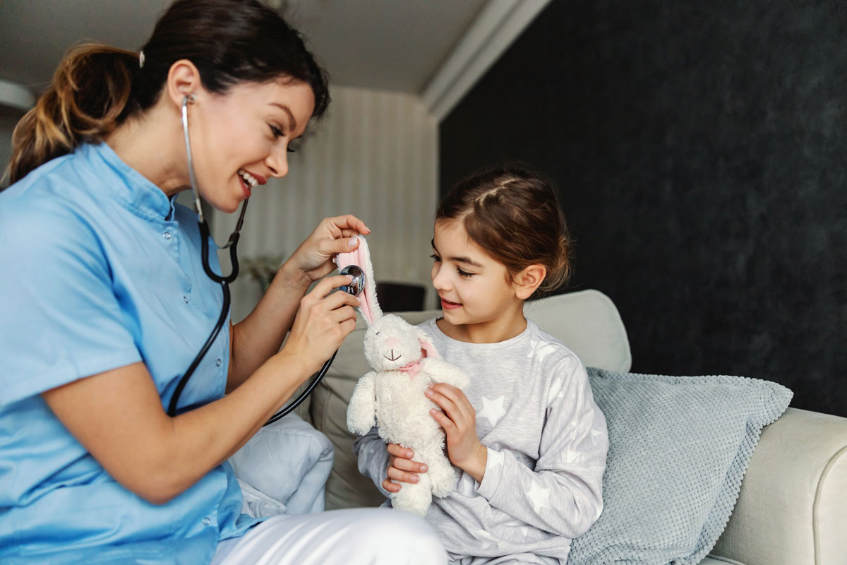 PDN Medical nurse in McAllen trying to relax girl so she is pretending to examining her bunny with stethoscope.